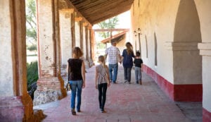 Family walking La Purisima Mission Halls in Lompoc